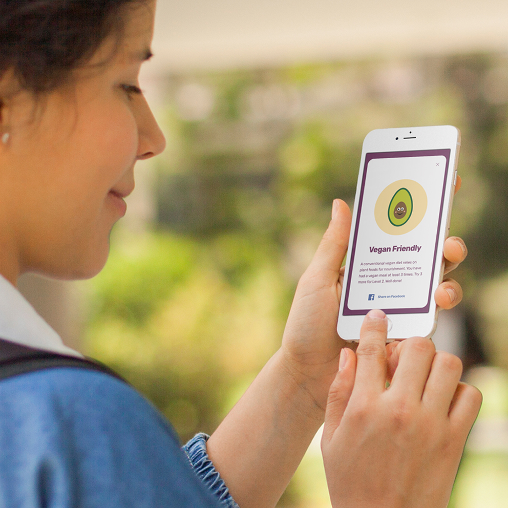Student viewing a Food Tracker badge on a phone
